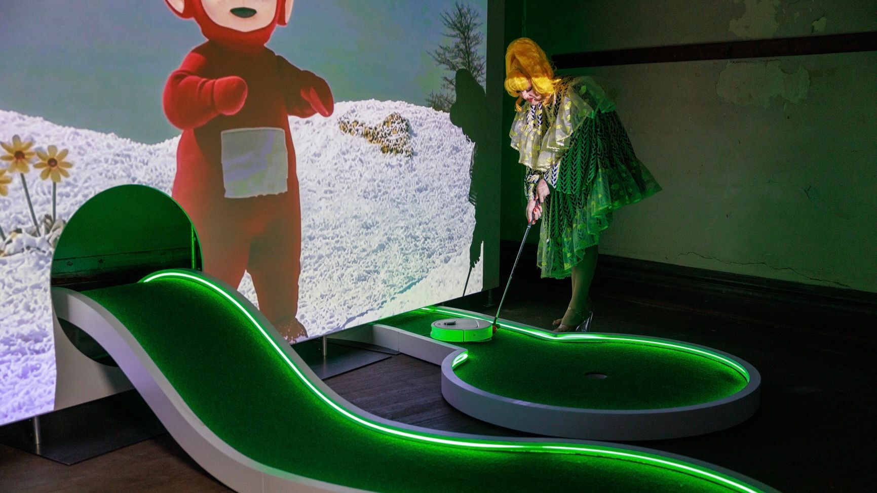  Someone lining up to try Soda Jerk's Swingers hole, a winding carpet with a projected teletubby watching over