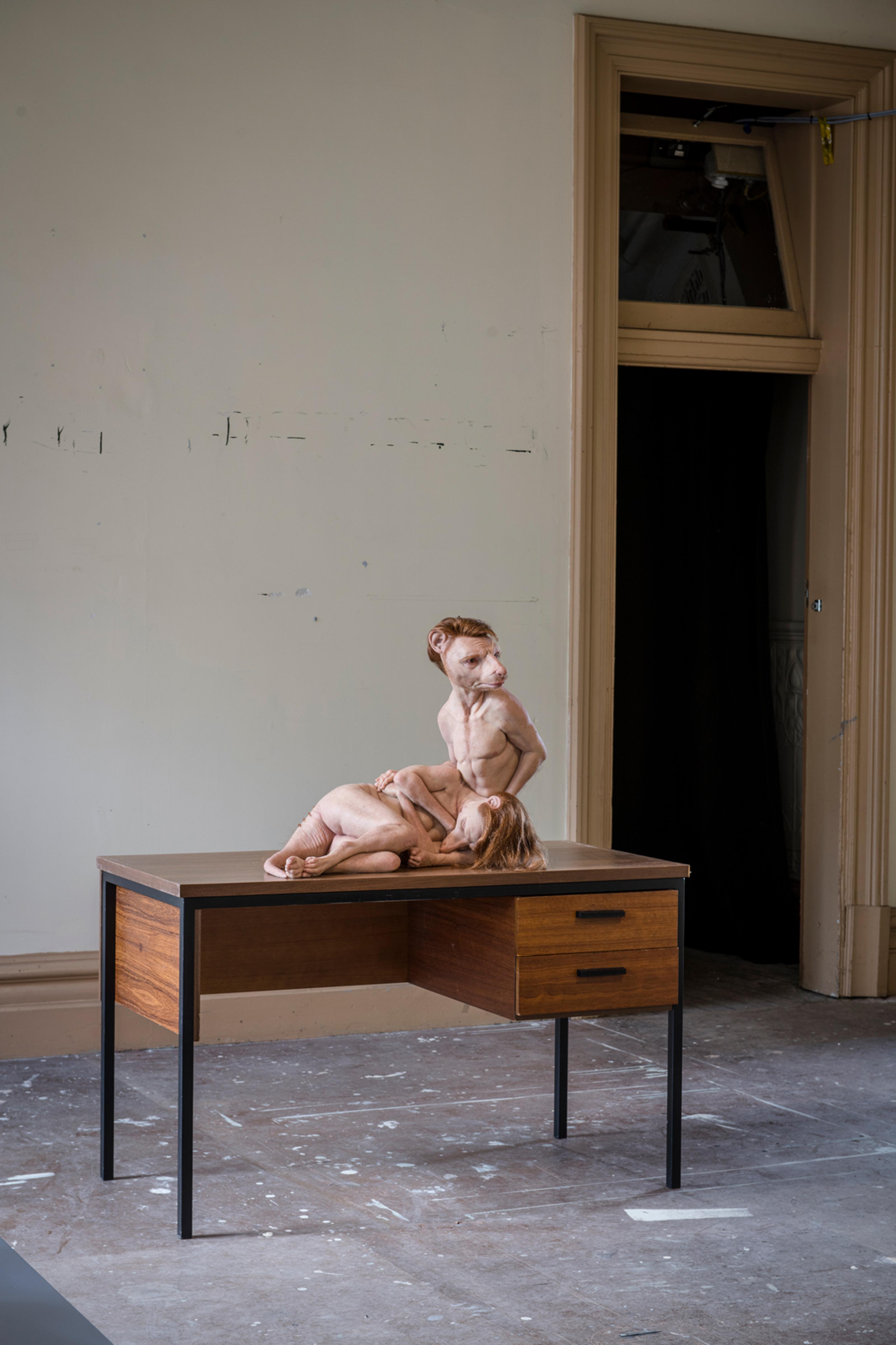 Installation view of Patricia Piccinini's work While She Sleeps of two thylacines displayed on a discarded desk from the station's rooms.