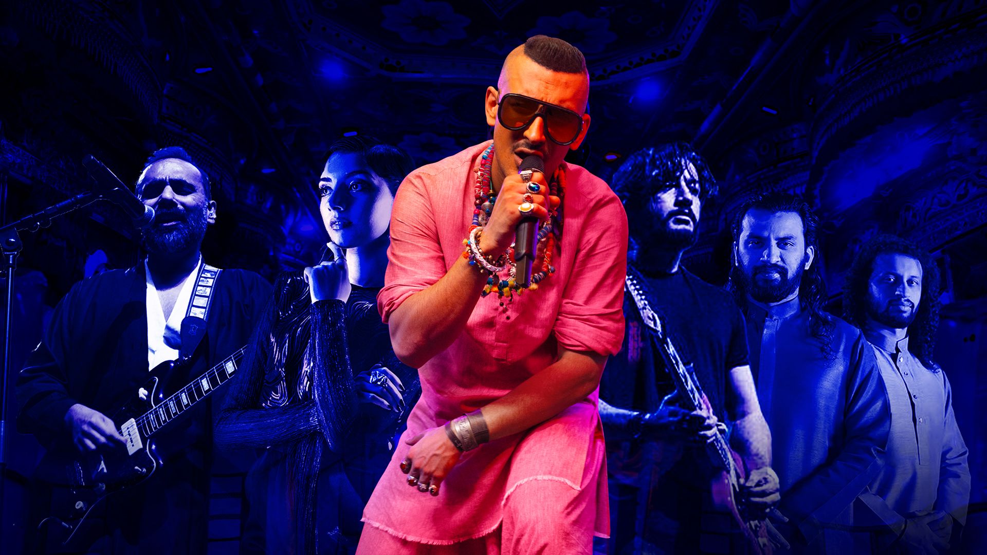 A singer dressed in pink, surrounded by five musicians lit by dim blue light.